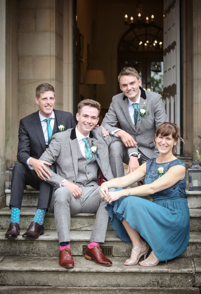 gay couple, groom and groom with best man and best lady sat down