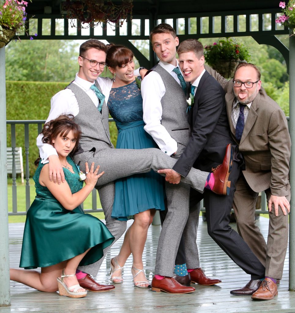playful scene at wedding of gay couple and friends