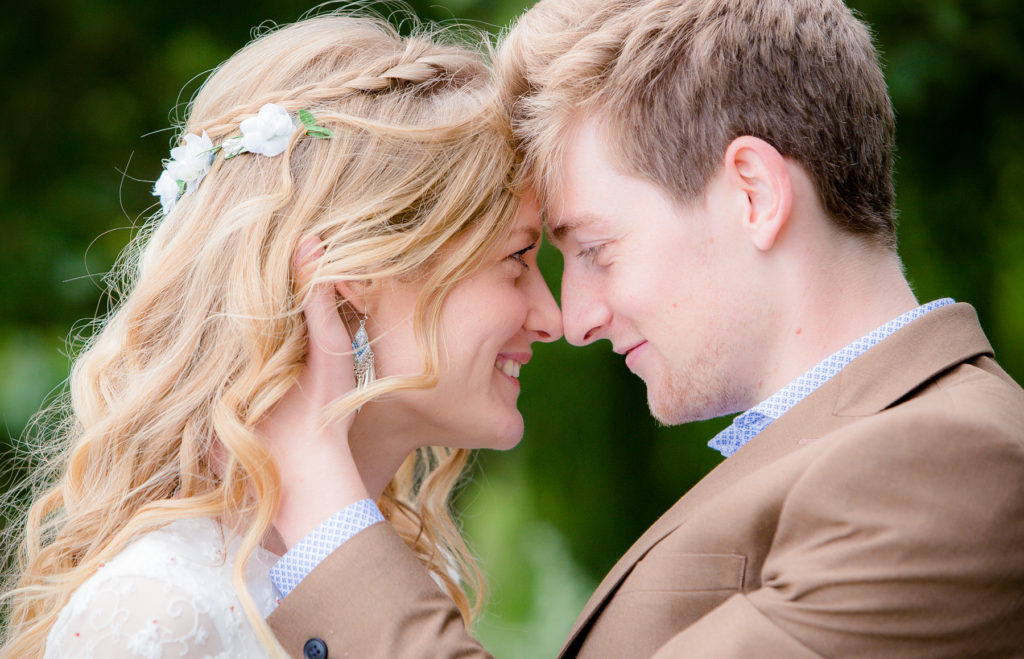 Bride and groom heads together loving moment