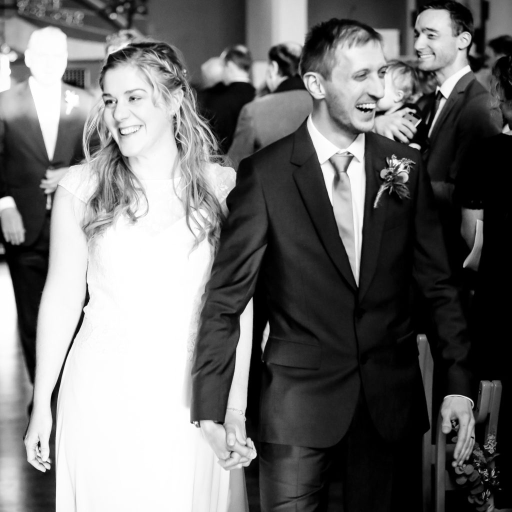Bride and groom happy and excited to leave church married