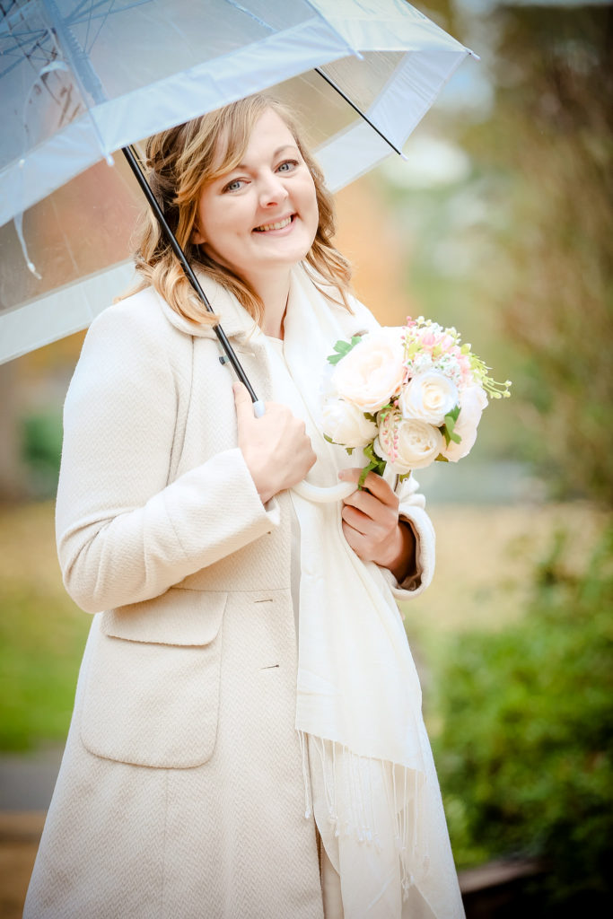Covid bride under umbrella