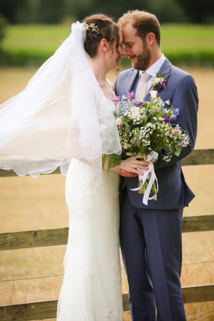 bride and groom moment in golden fields in Lincolnshire