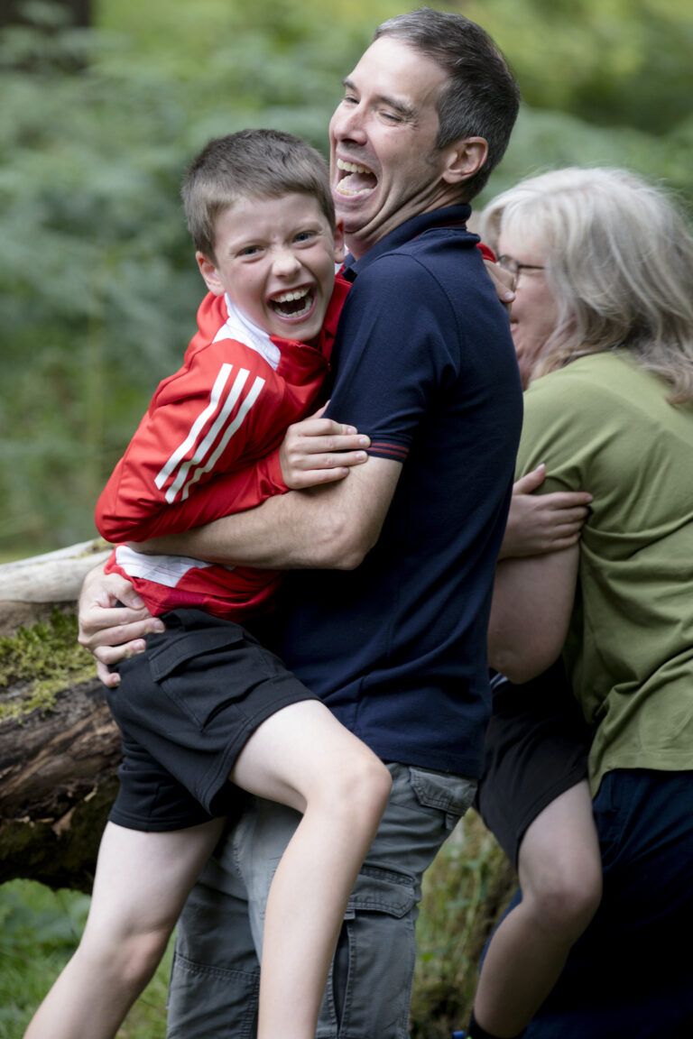dad hugging son laughing