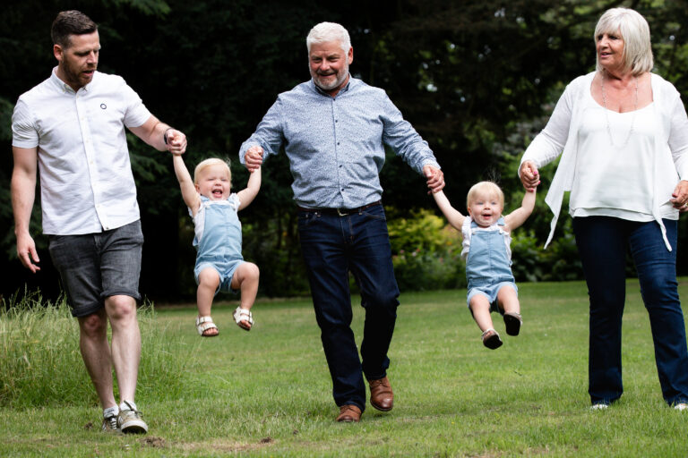 grandad swinging little kids