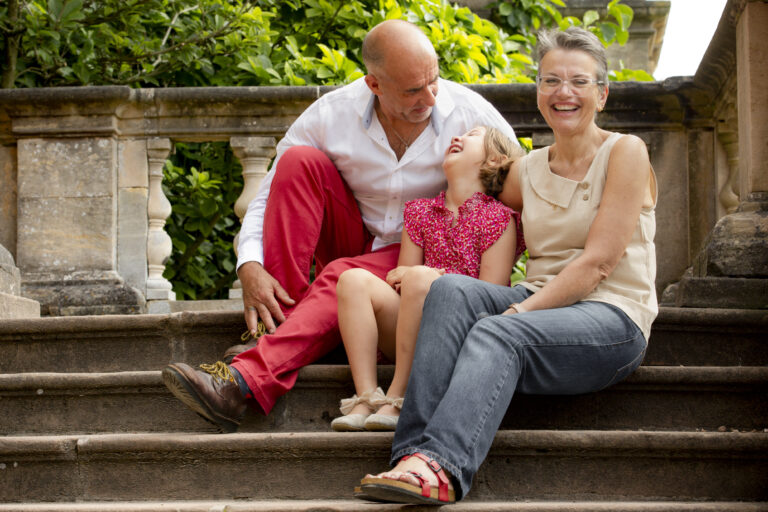 grandparents with granddaughter laughing at Wollaston park