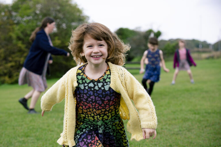 young girl running towards camera