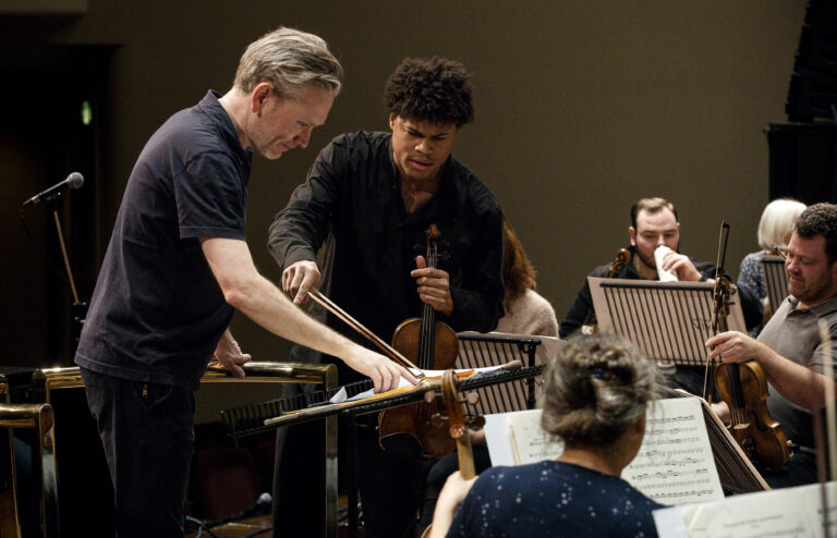 Braimah Kanneh-Mason with the conductor discussing the score