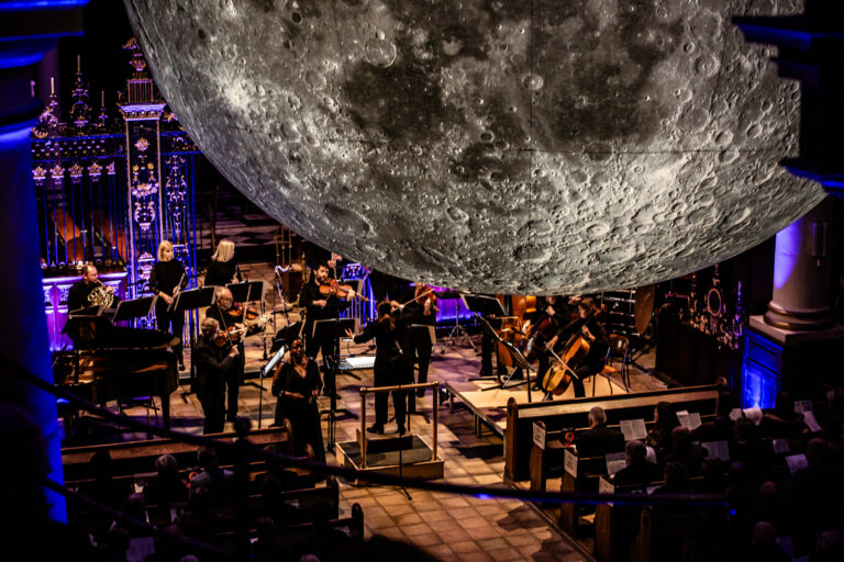 Sinfonia Viva at Derby Cathedral. Moon hanging down in front of orchestra.