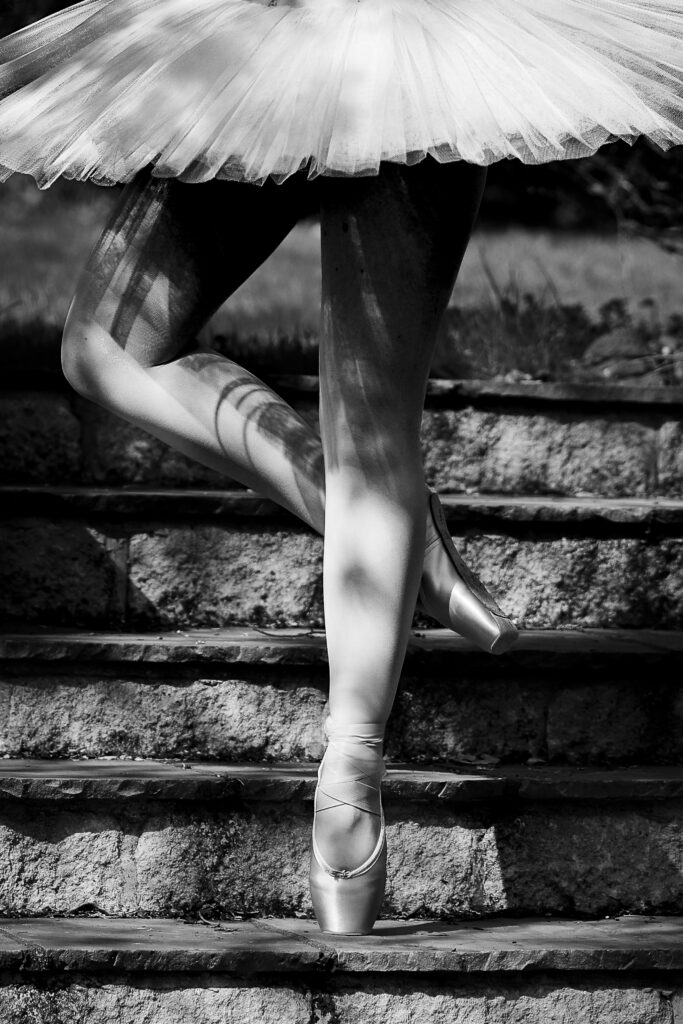 Black and white photo of a ballet dancers legs and Pointe shoes