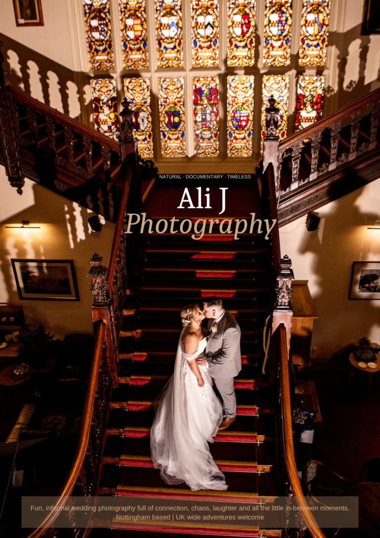 Bride and groom kissing on a grand wooden staircase during their wedding, photographed by Ali J Photography at Beaumanor Hall, in the East Midlands