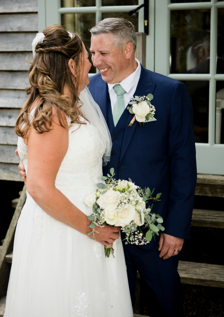 Bride and groom laughing together outside a rustic timber shepherds, Perkins, Plum tree - natural wedding photography by Ali J, Nottingham
