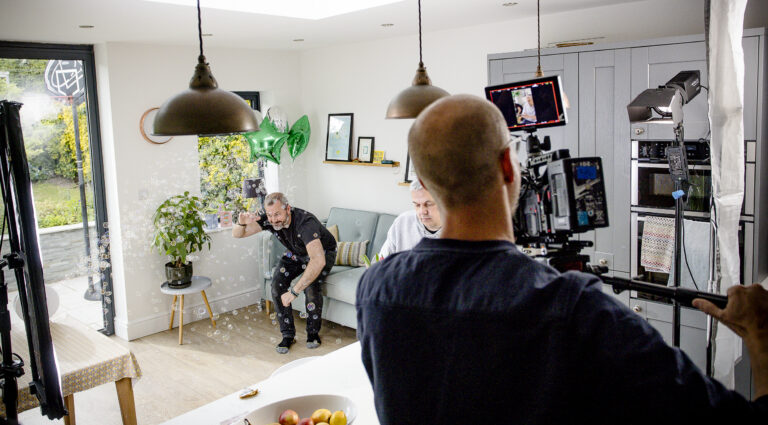 Lectio 365 app photo shoot, camera man in focus with bubbles and tech in background